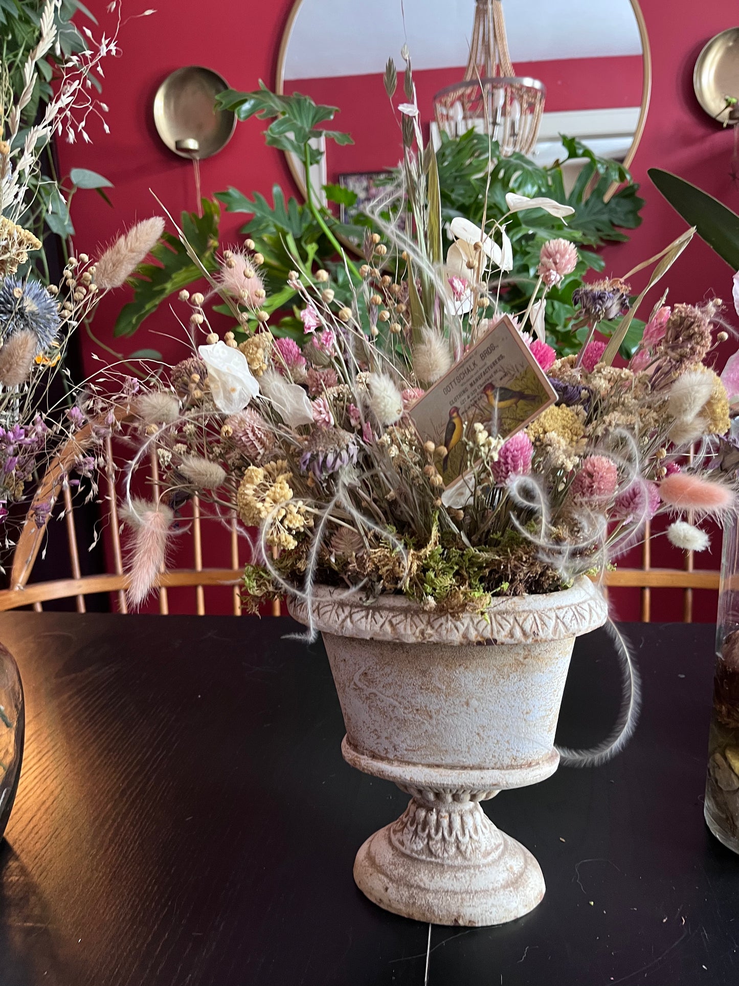 Dried arrangement in vintage cast iron urn